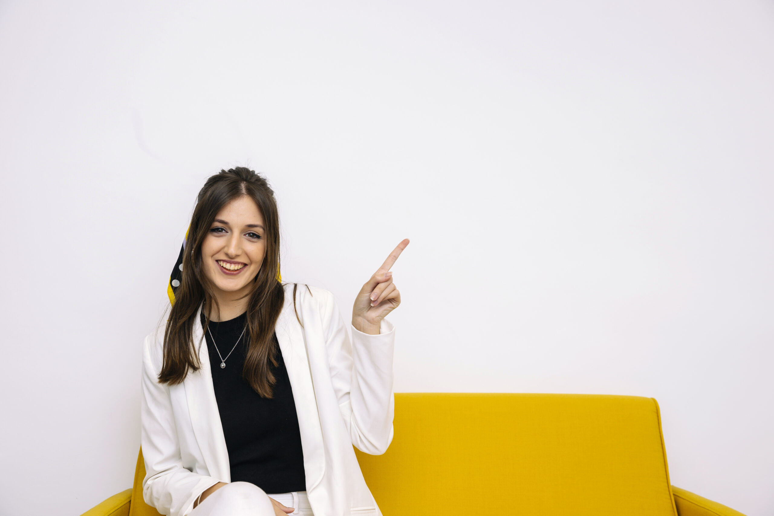 smiling-beautiful-young-woman-pointing-upward (1)